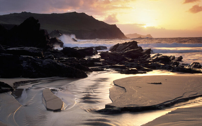 Sunset at rocky coastal beach