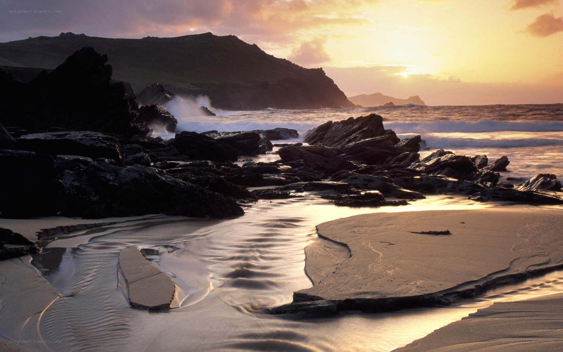 Sunset at rocky coastal beach
