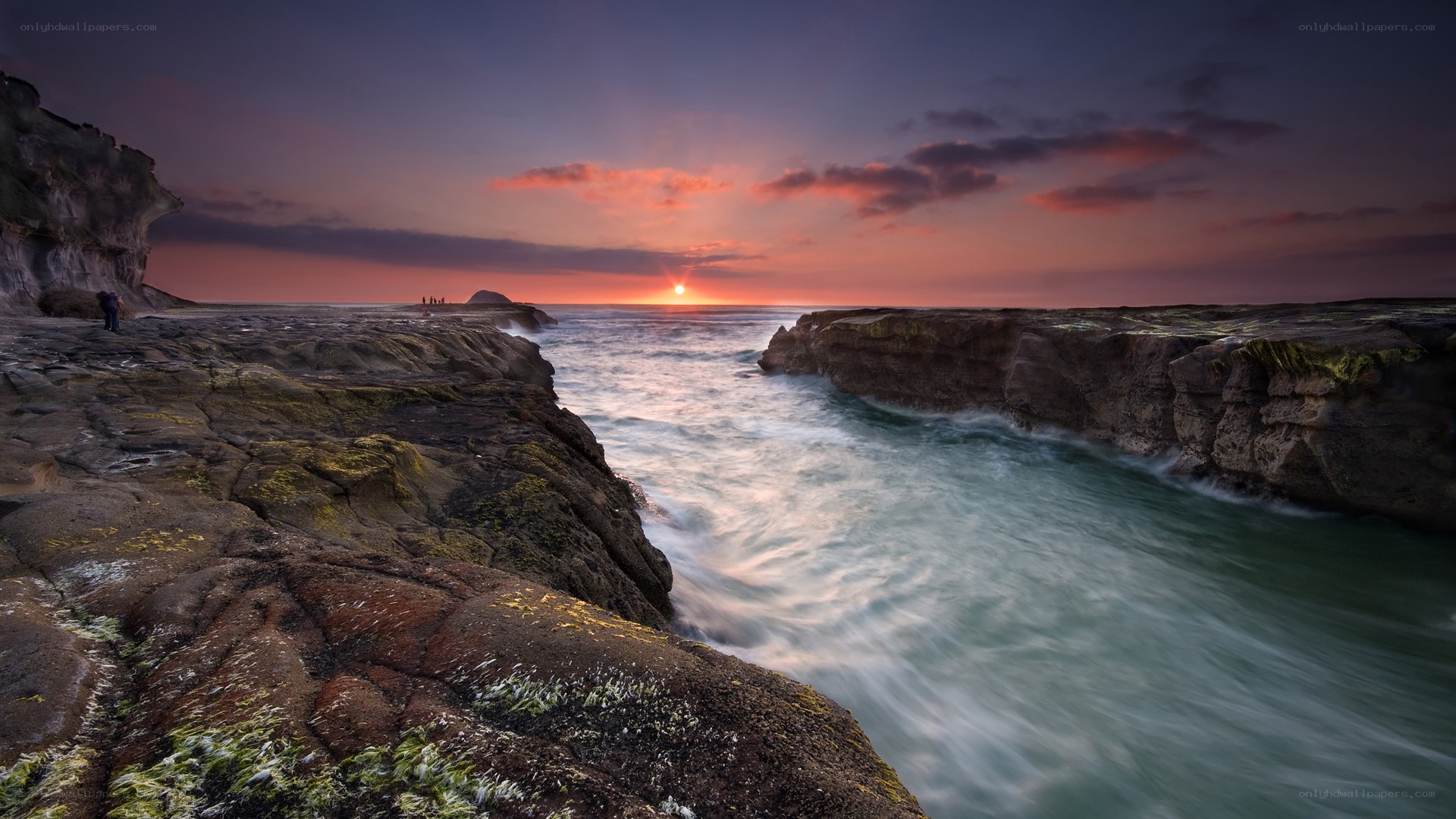 Sunset at rocky coastal inlet