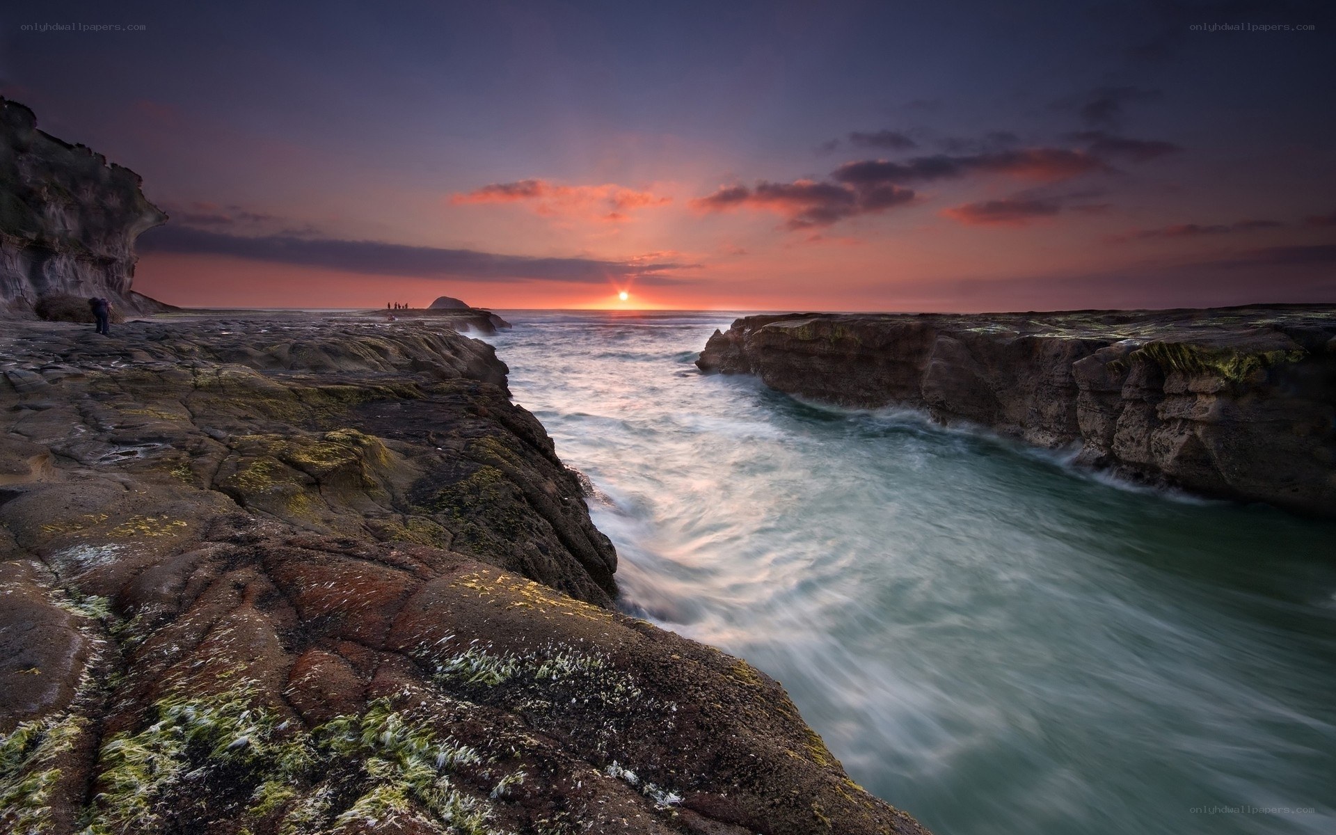 Sunset at rocky coastal inlet