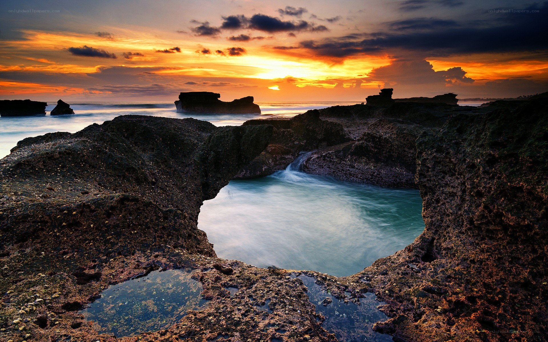 Sunset at rocky coastal pool