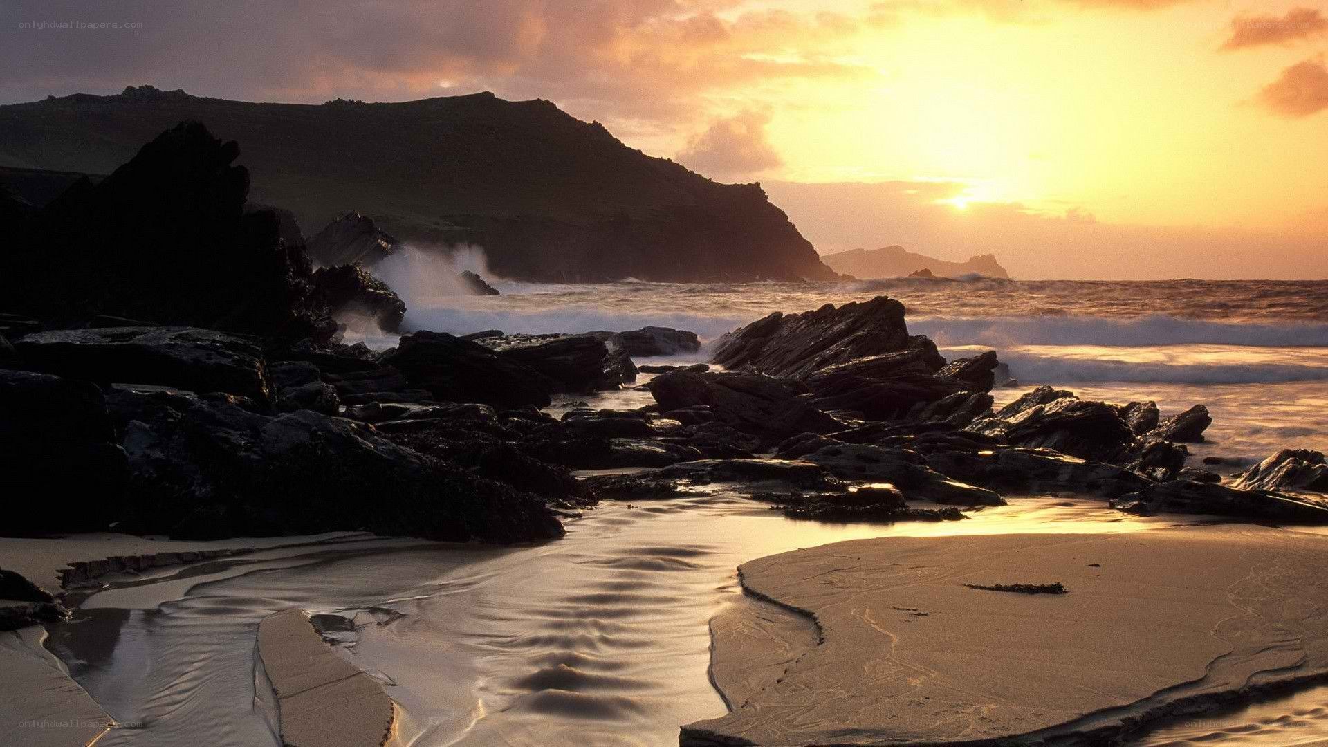 Sunset at rocky coastline