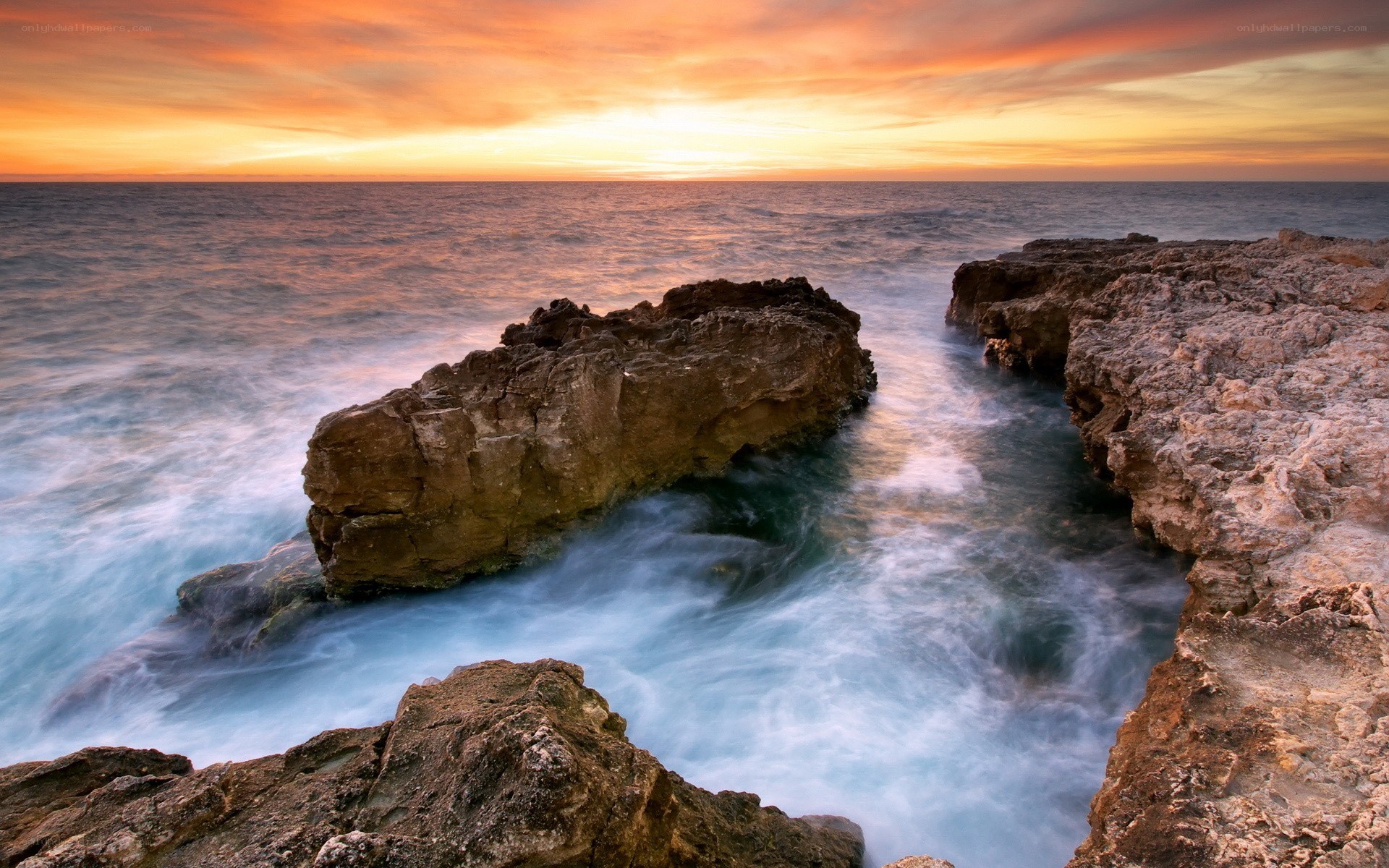 Sunset at rocky coastline