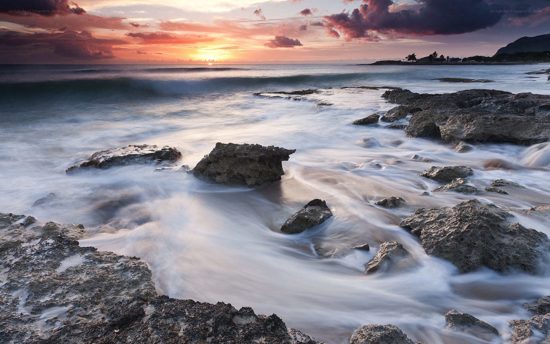 Sunset at rocky shoreline