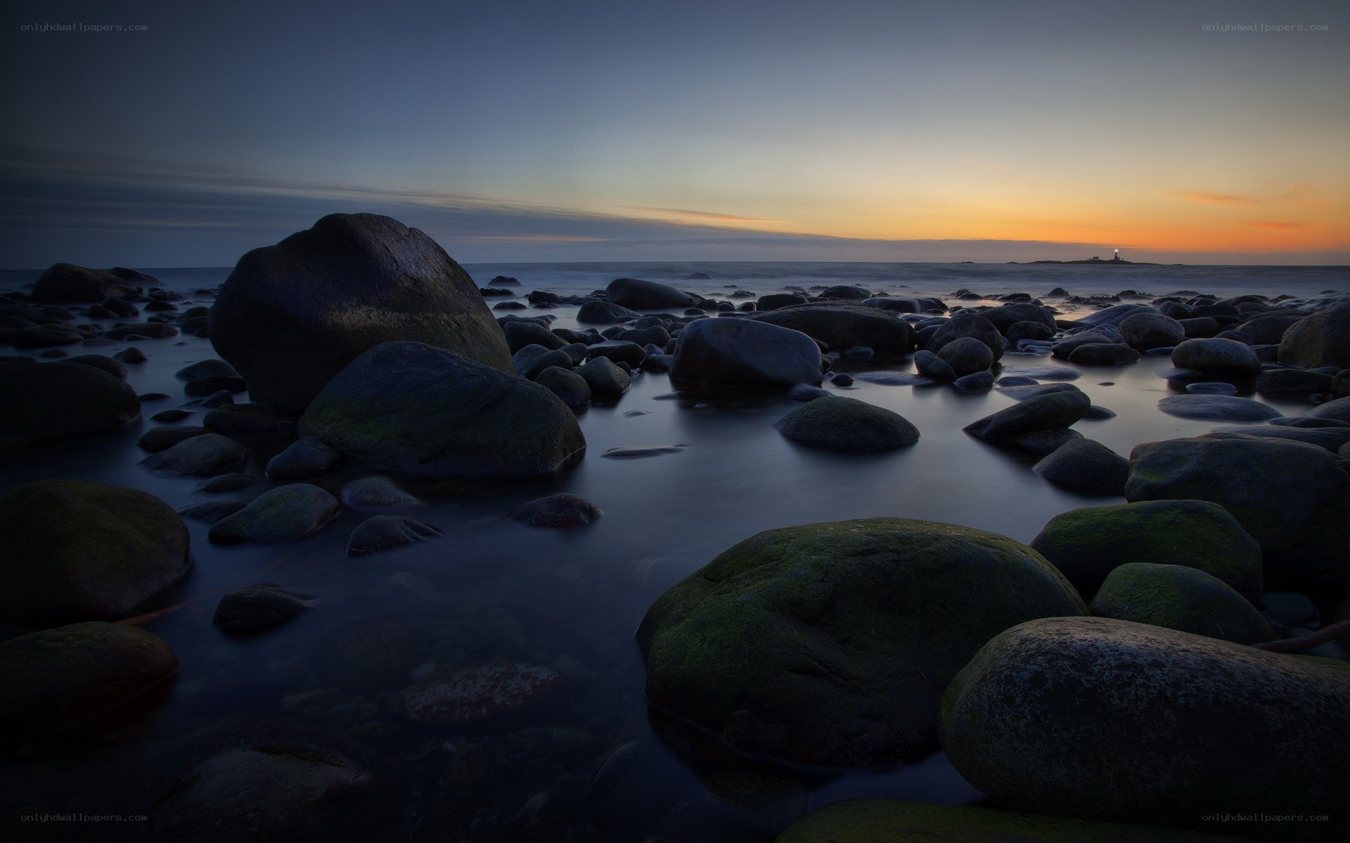 Sunset at rocky shoreline