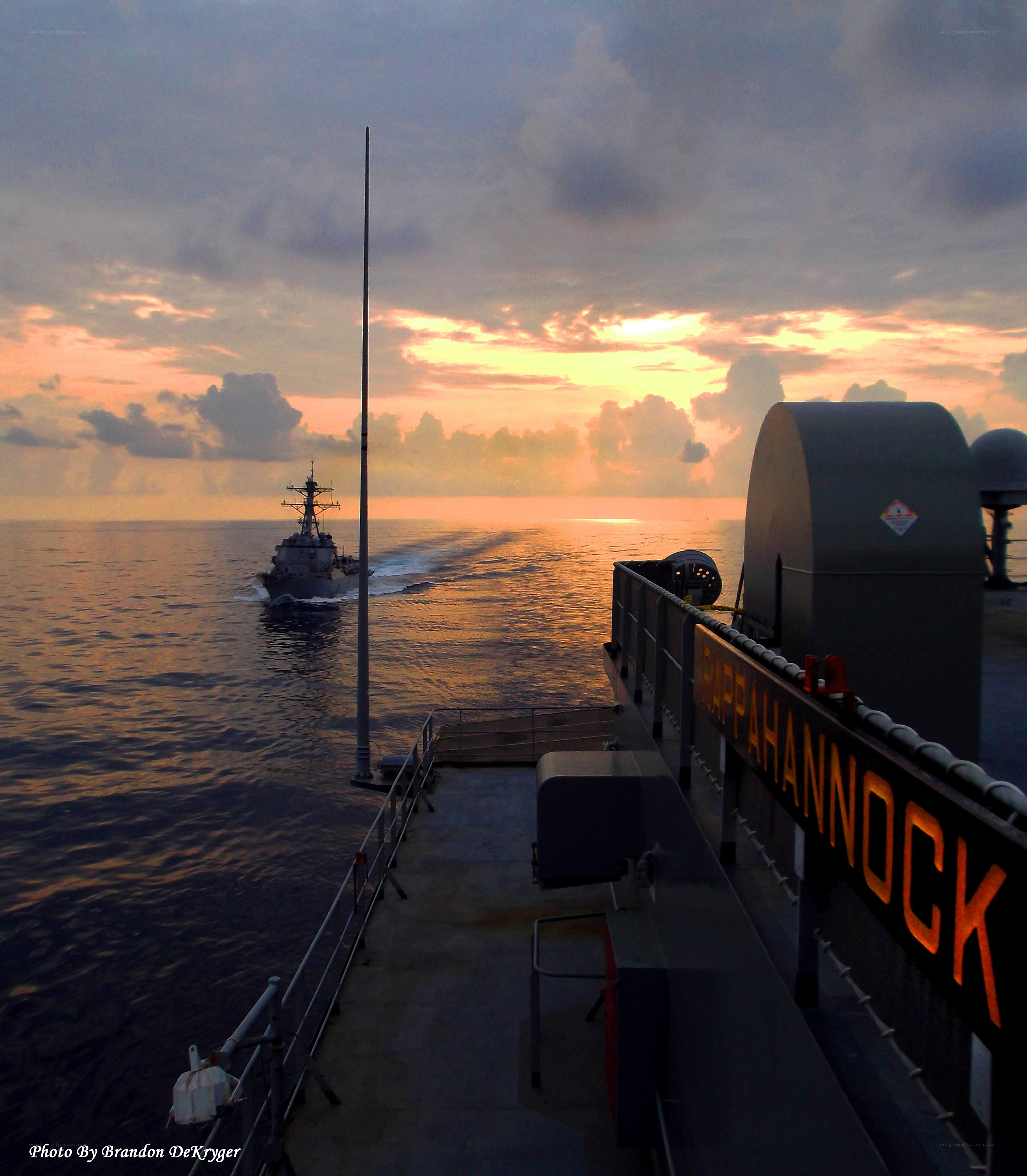 Sunset at sea with naval ships