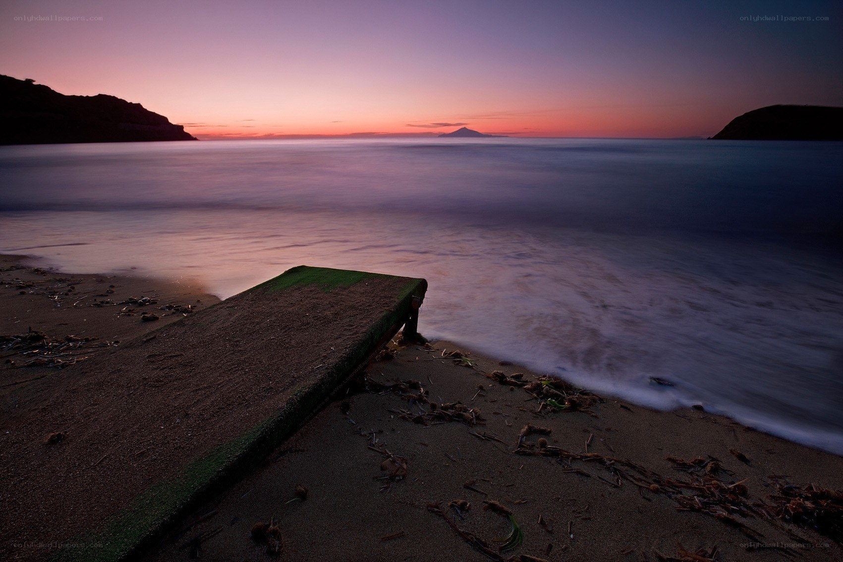 Sunset at the beach with a dock