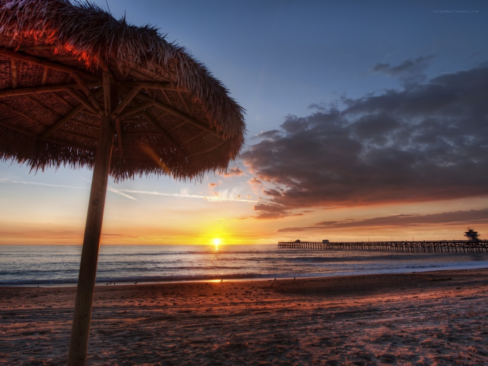 Sunset at the beach with a pier