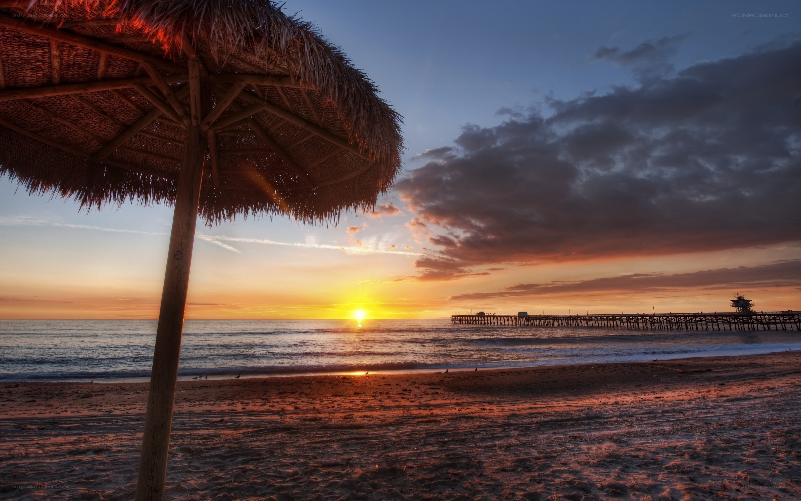 Sunset at the beach with a pier