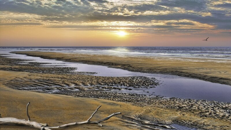 Sunset at the beach with a river
