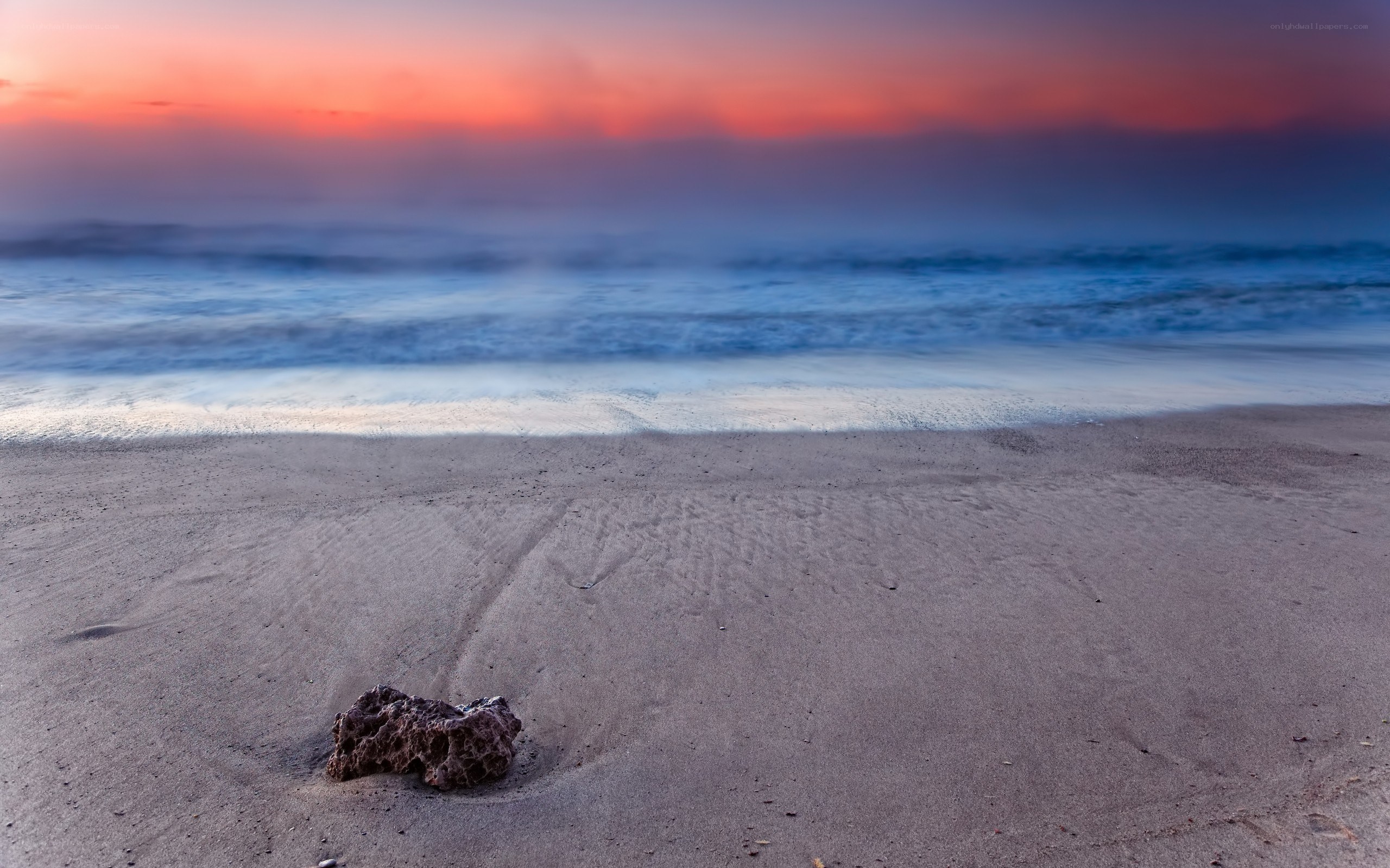 Sunset at the beach with a rock