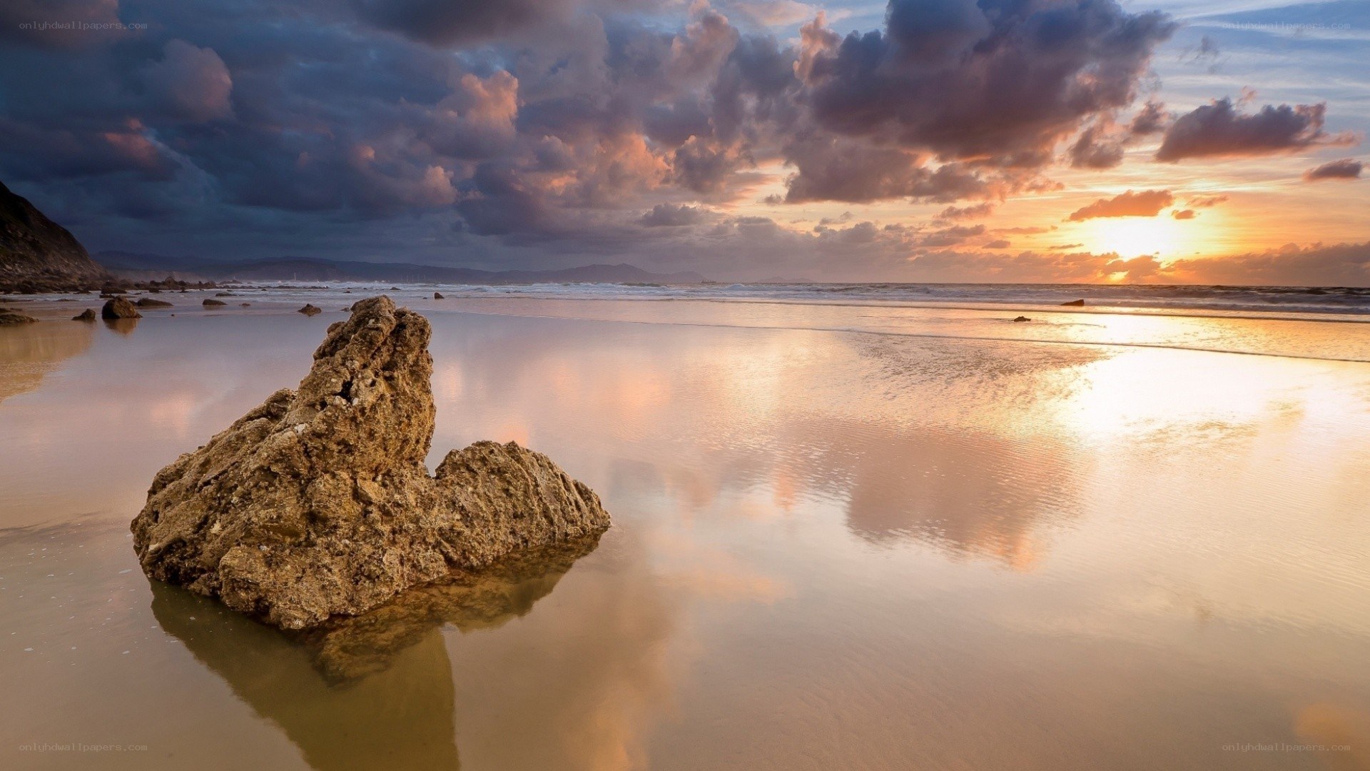 Sunset at the beach with a rock
