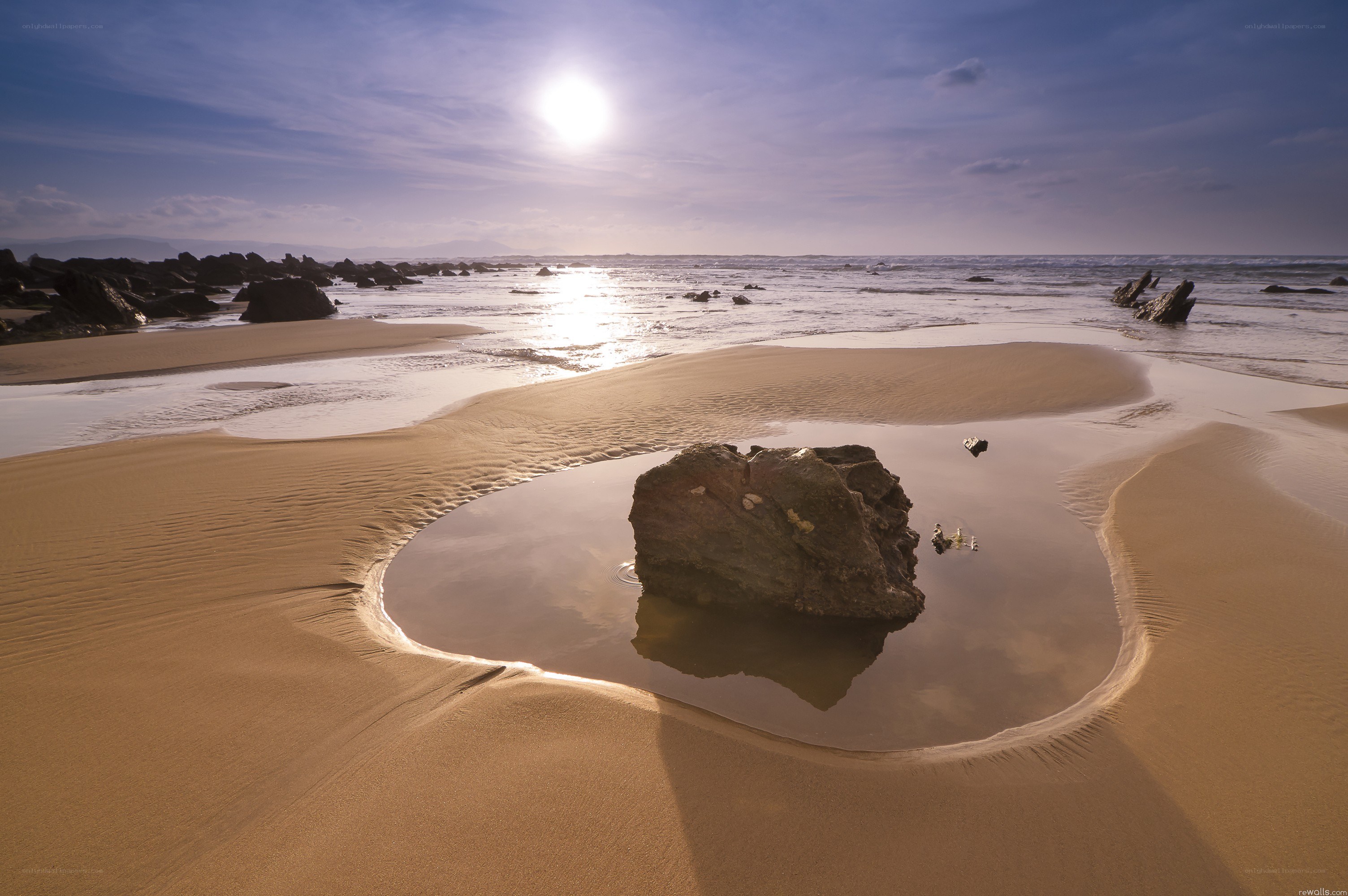 Sunset at the beach with a rock pool
