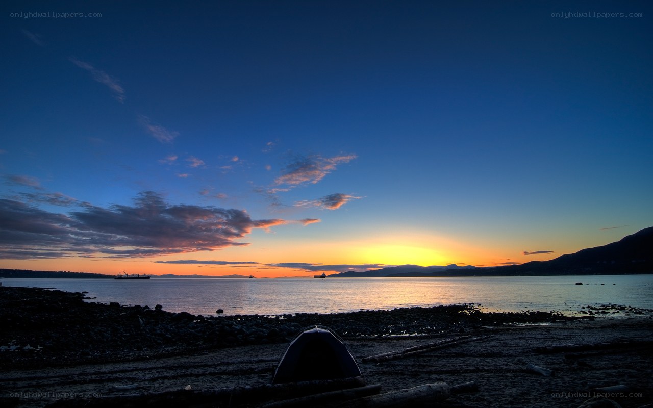 Sunset at the beach with a tent