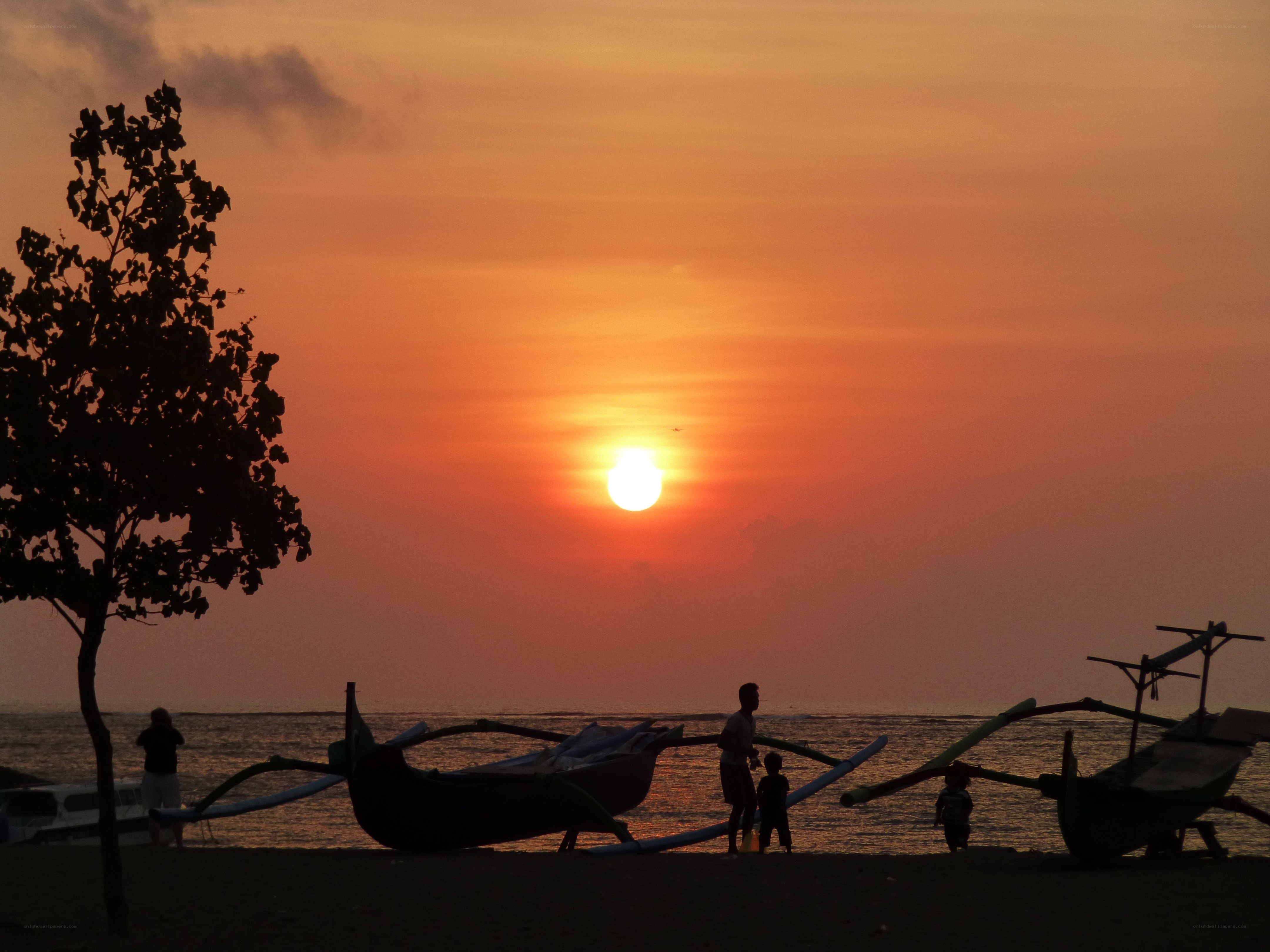 Sunset at the beach with boats