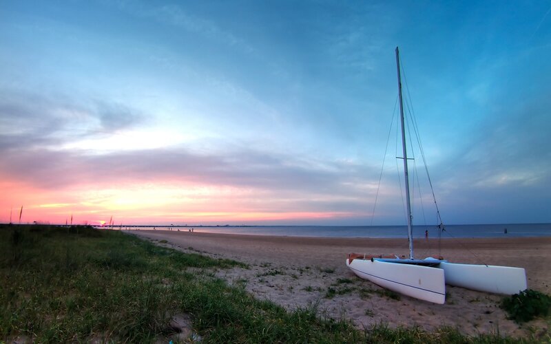 sunset at the beach with catamaran