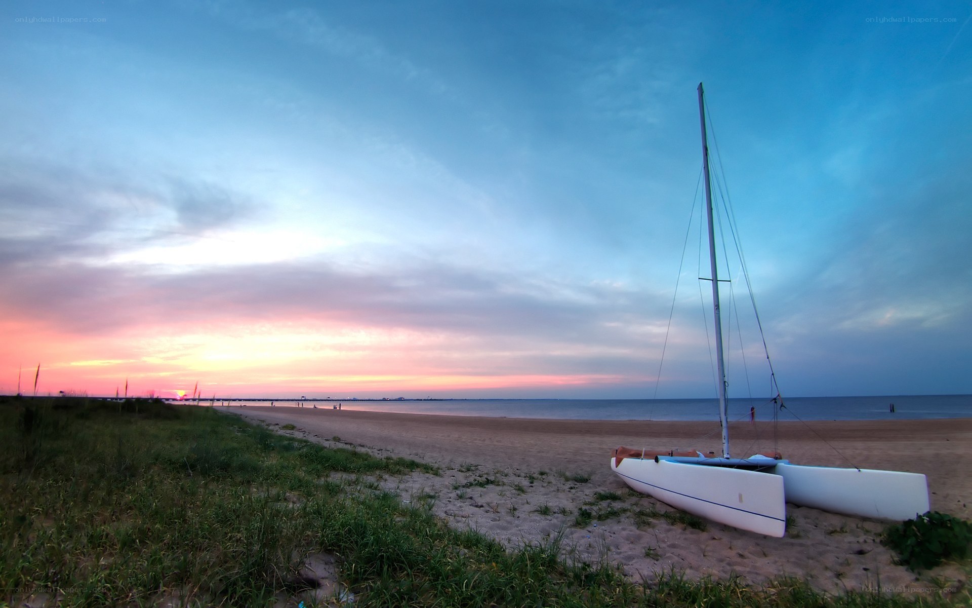 sunset at the beach with catamaran