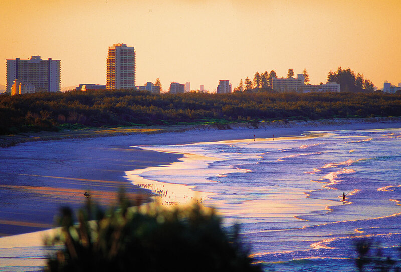 Sunset at the beach with city skyline