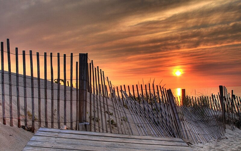 sunset at the beach with fence