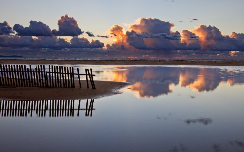 Sunset at the beach with fence
