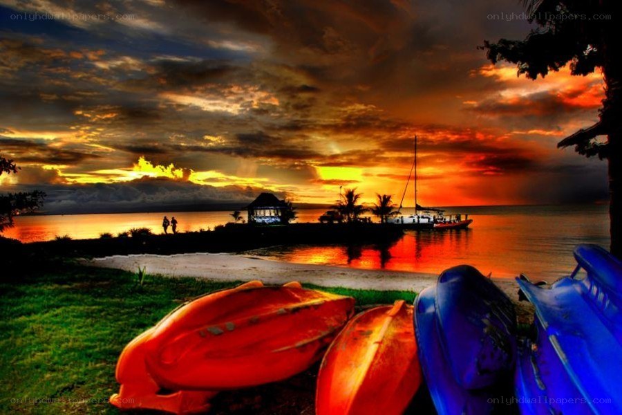 Sunset at the beach with kayaks