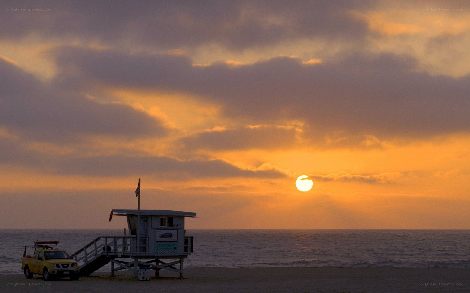 Sunset at the beach with lifeguard tower