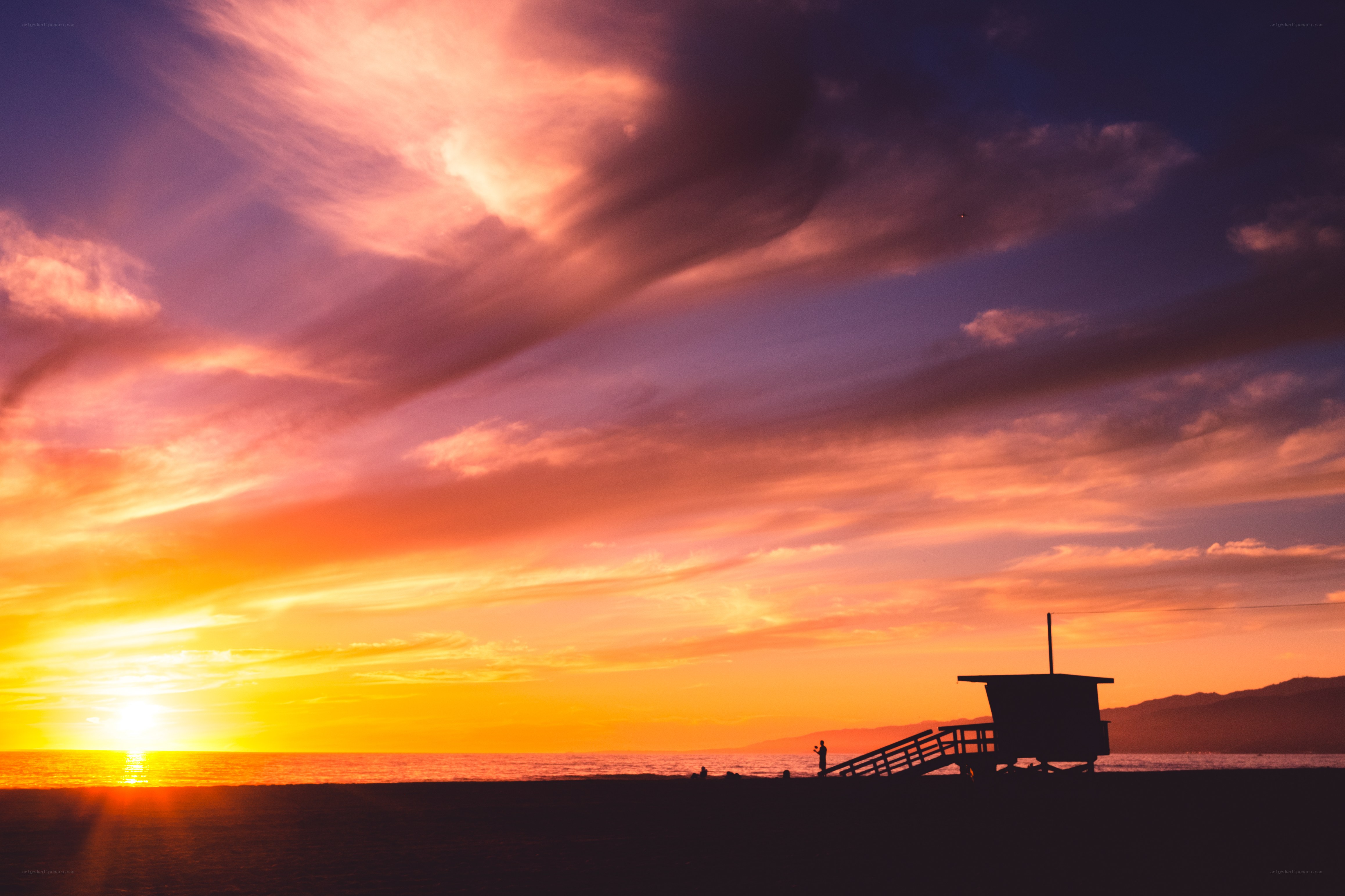 Sunset at the beach with lifeguard tower