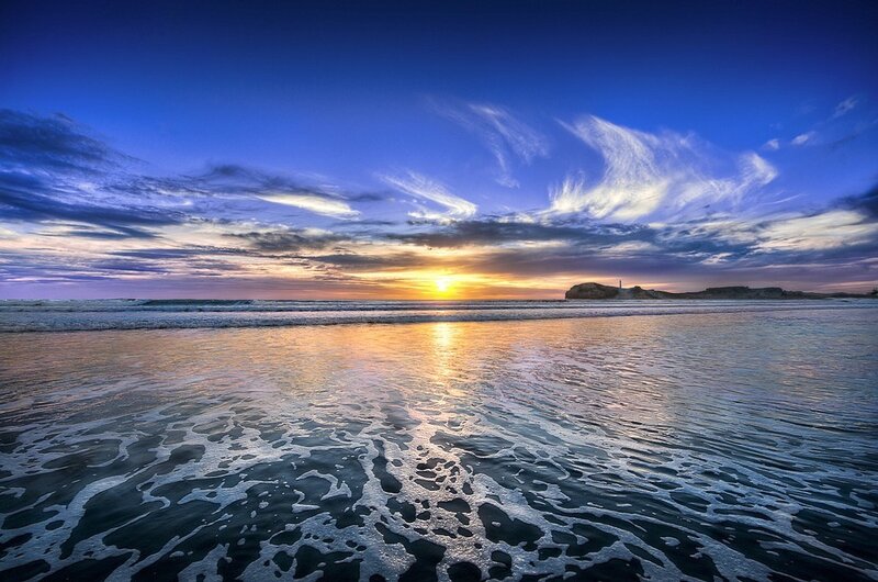 Sunset at the beach with lighthouse