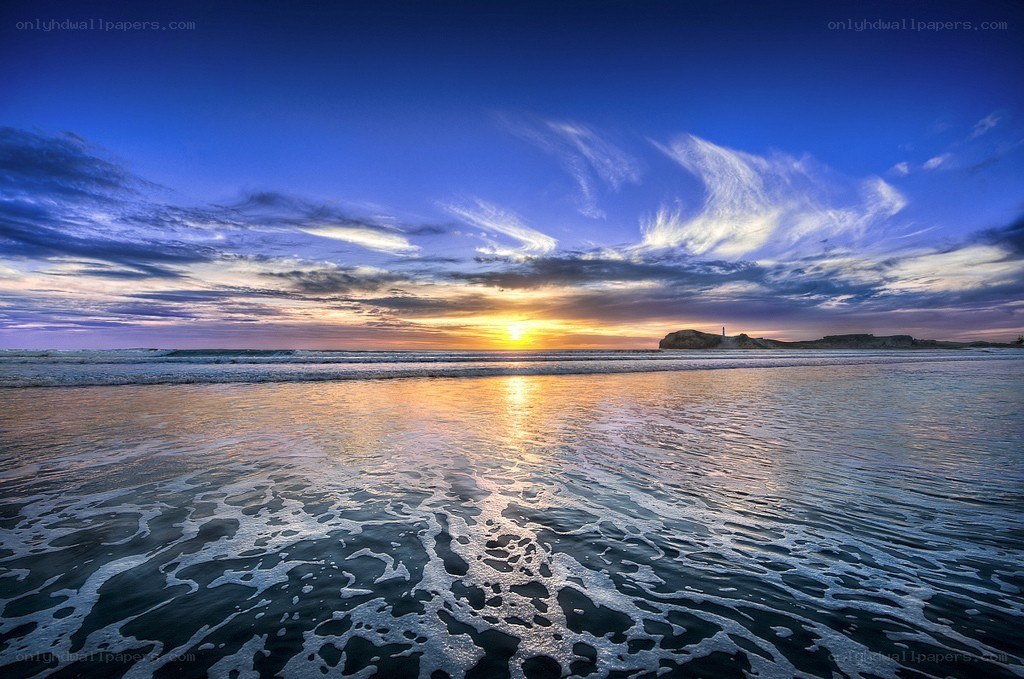 Sunset at the beach with lighthouse