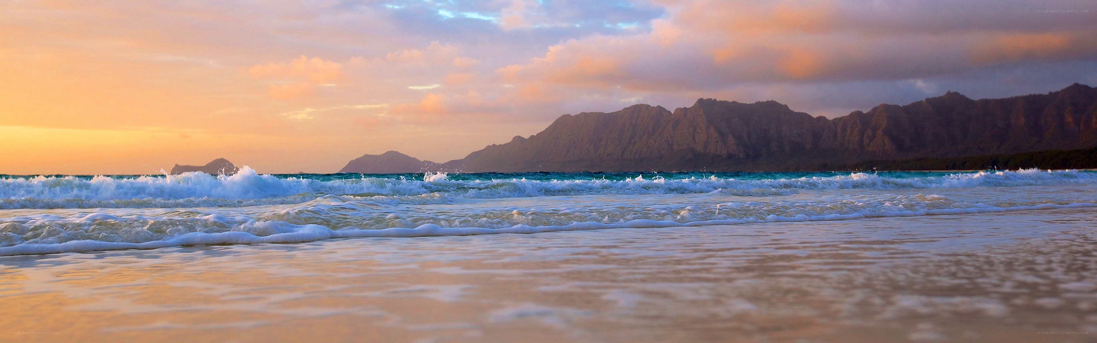 sunset at the beach with mountains