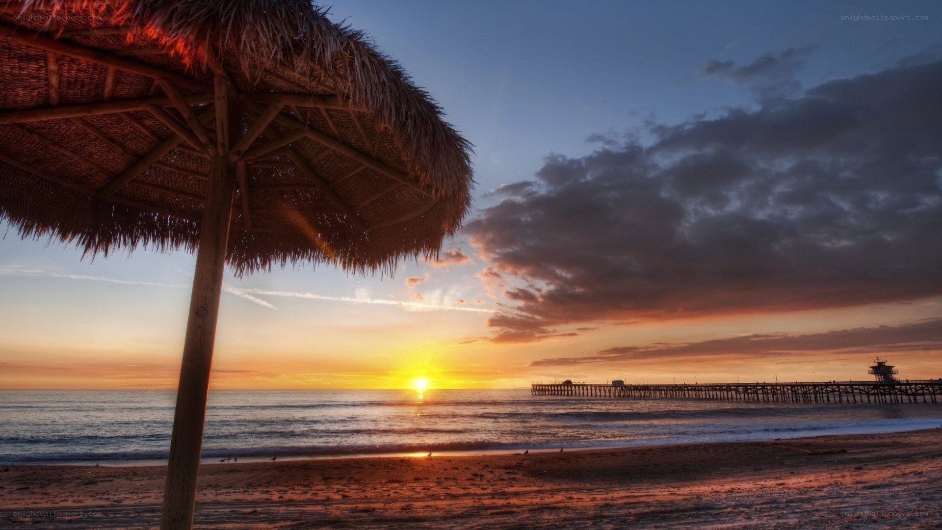 sunset at the beach with pier