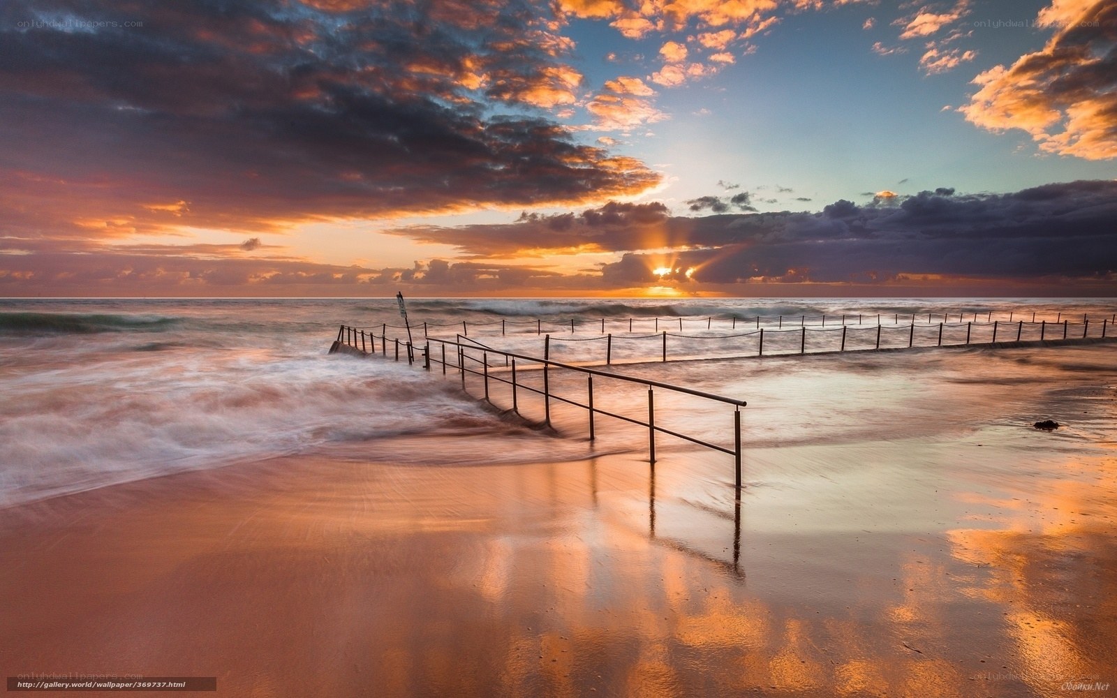 Sunset at the beach with railings
