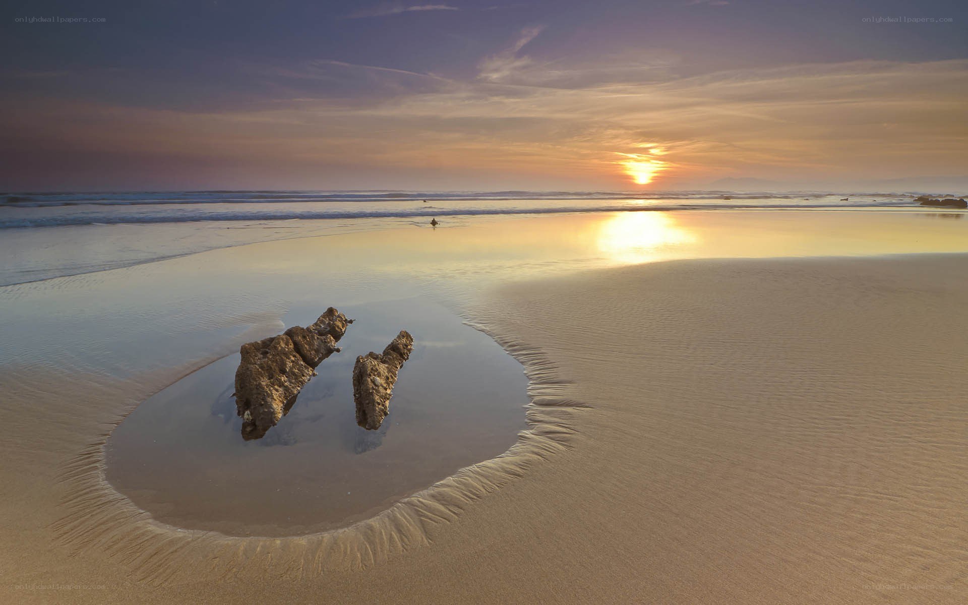 Sunset at the beach with rocks