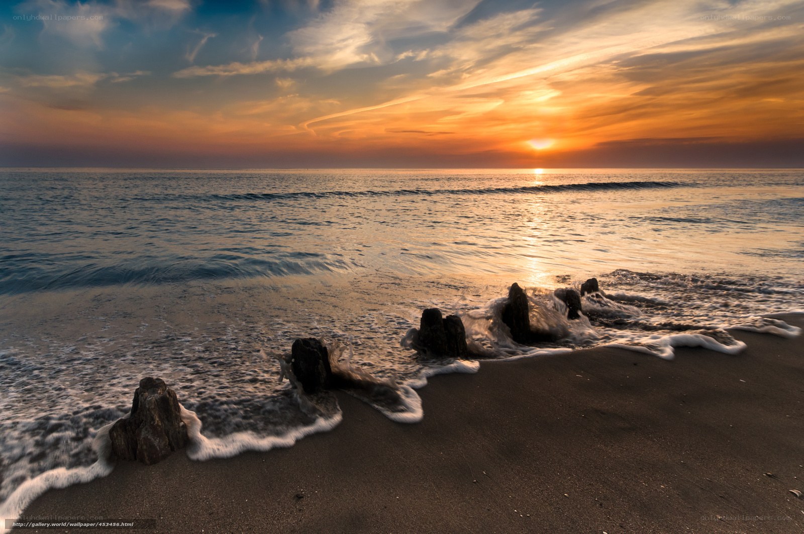 Sunset at the beach with rocks