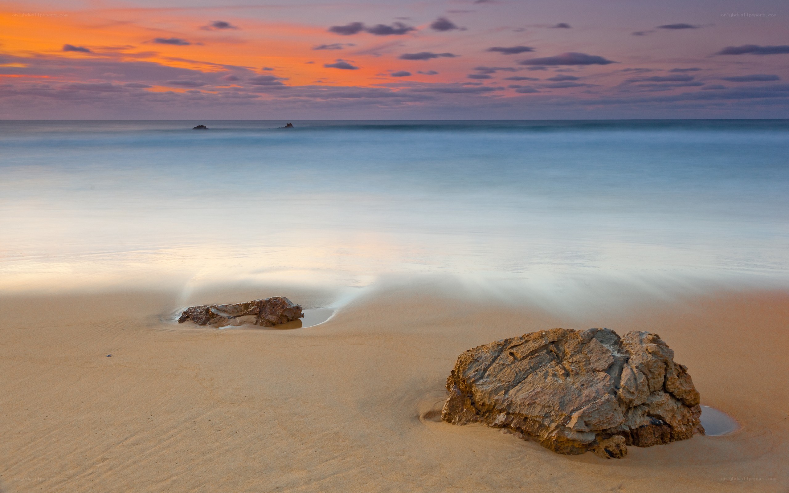 Sunset at the beach with rocks