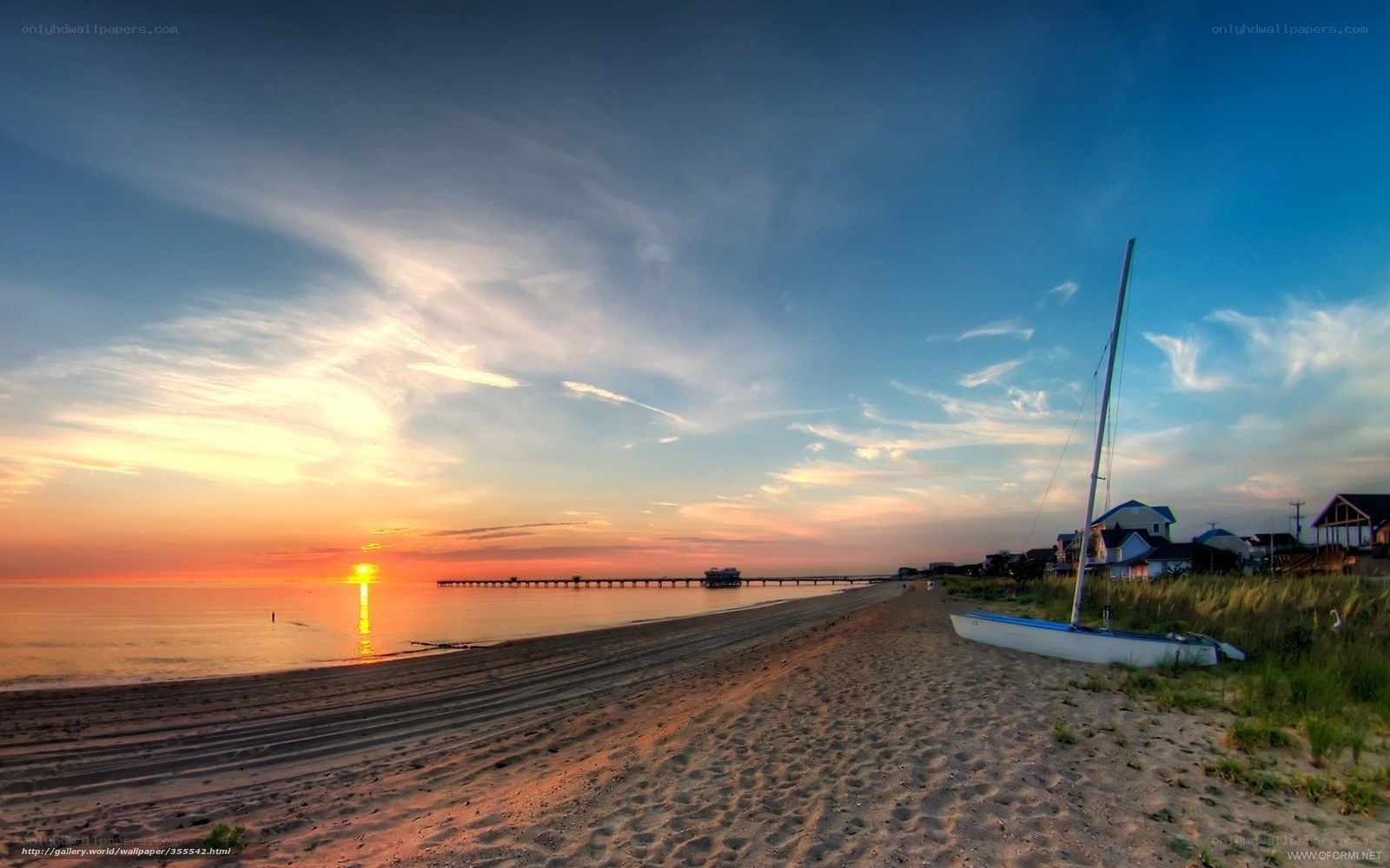 sunset at the beach with sailboat