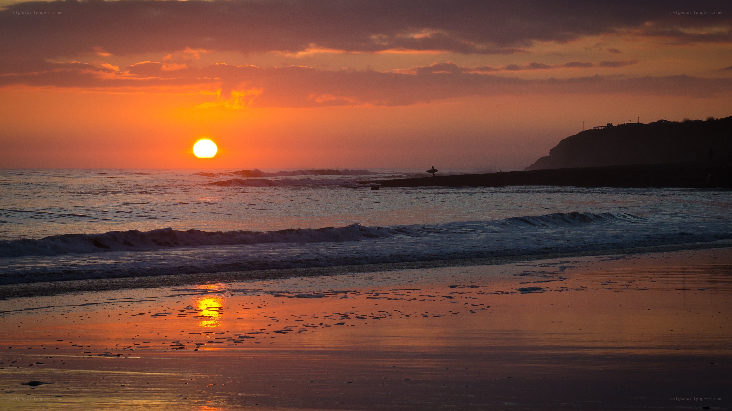 Sunset at the beach with surfer