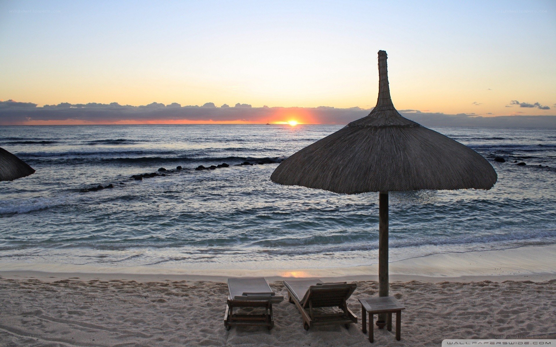 Sunset at the beach with umbrellas