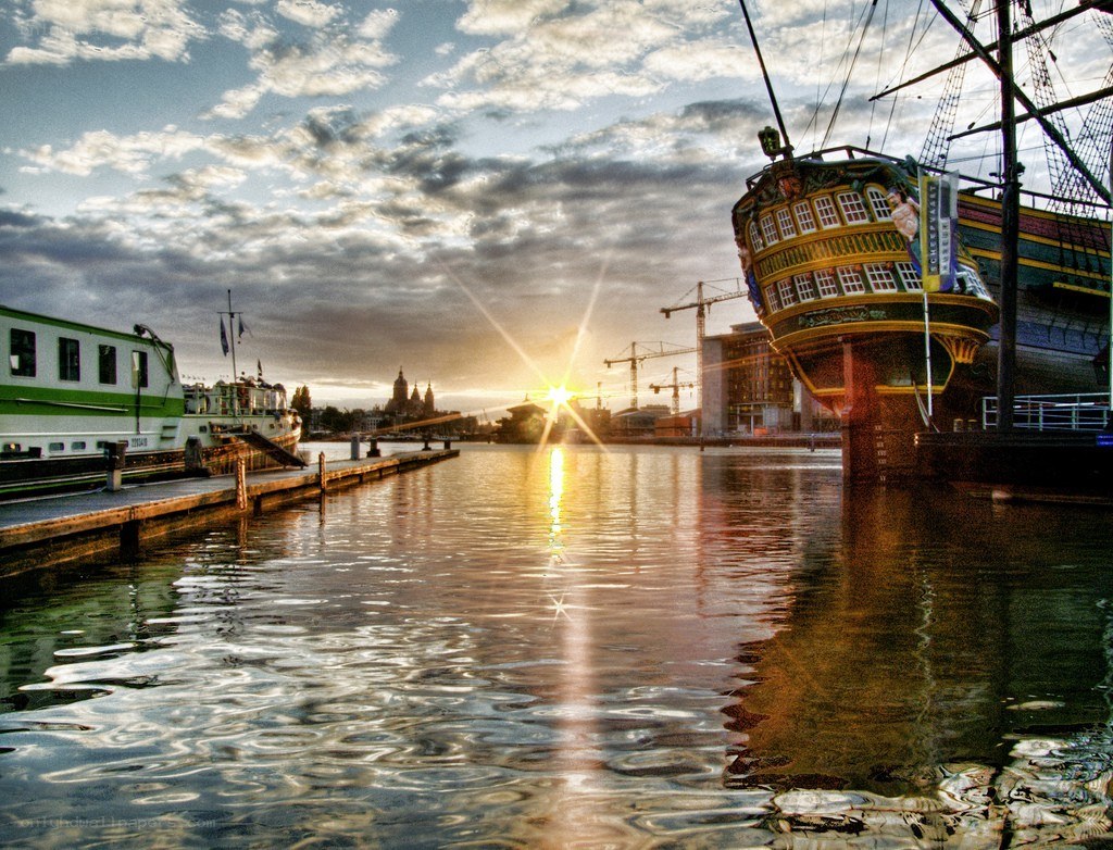 Sunset at the harbor with a tall ship