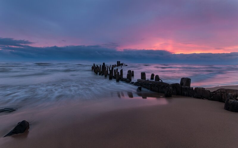 Sunset at the wooden breakwater