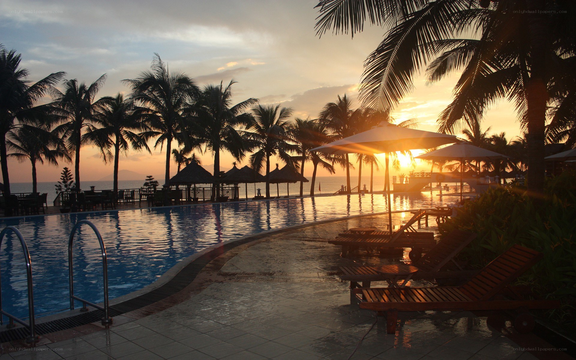 Sunset at tropical resort pool