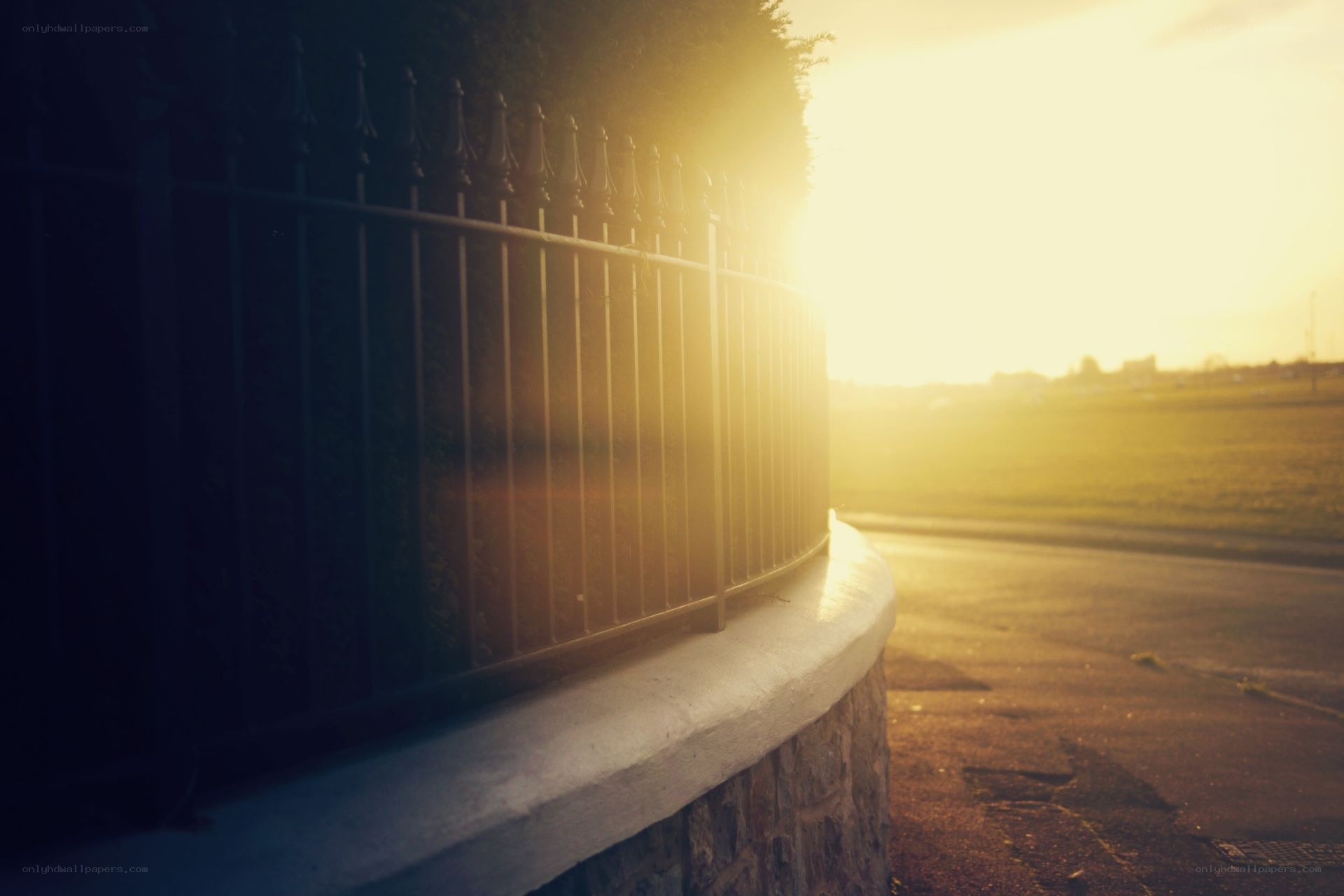 Sunset behind a fence