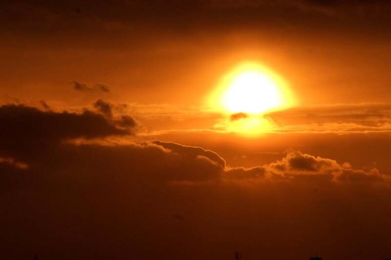 Sunset behind clouds
