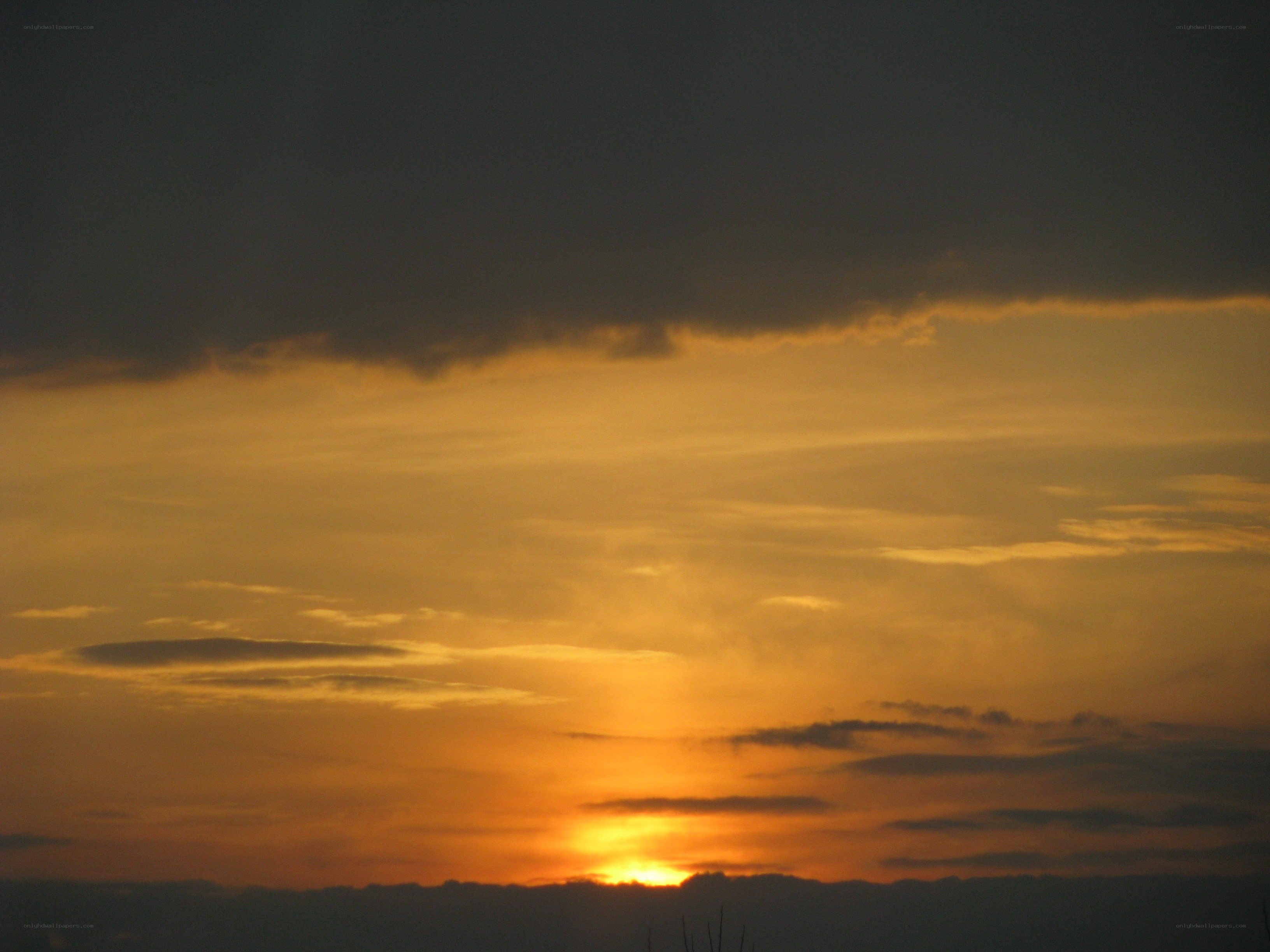 Sunset behind dark clouds