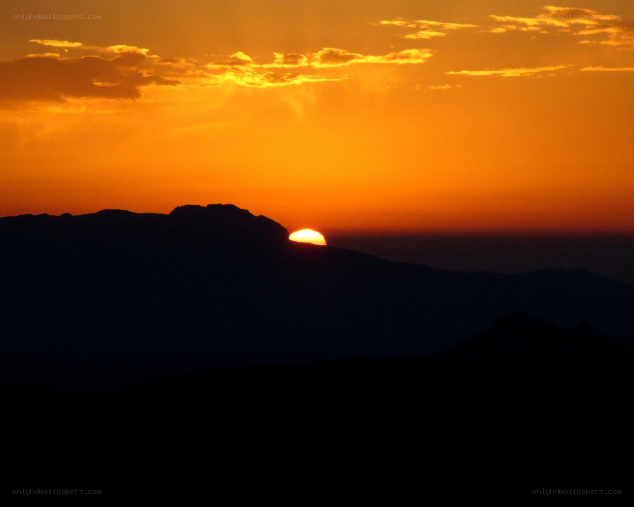 Sunset behind mountain silhouette