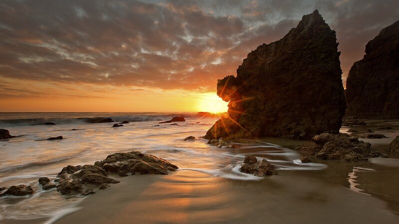 Sunset Behind Rock Formation — Orange