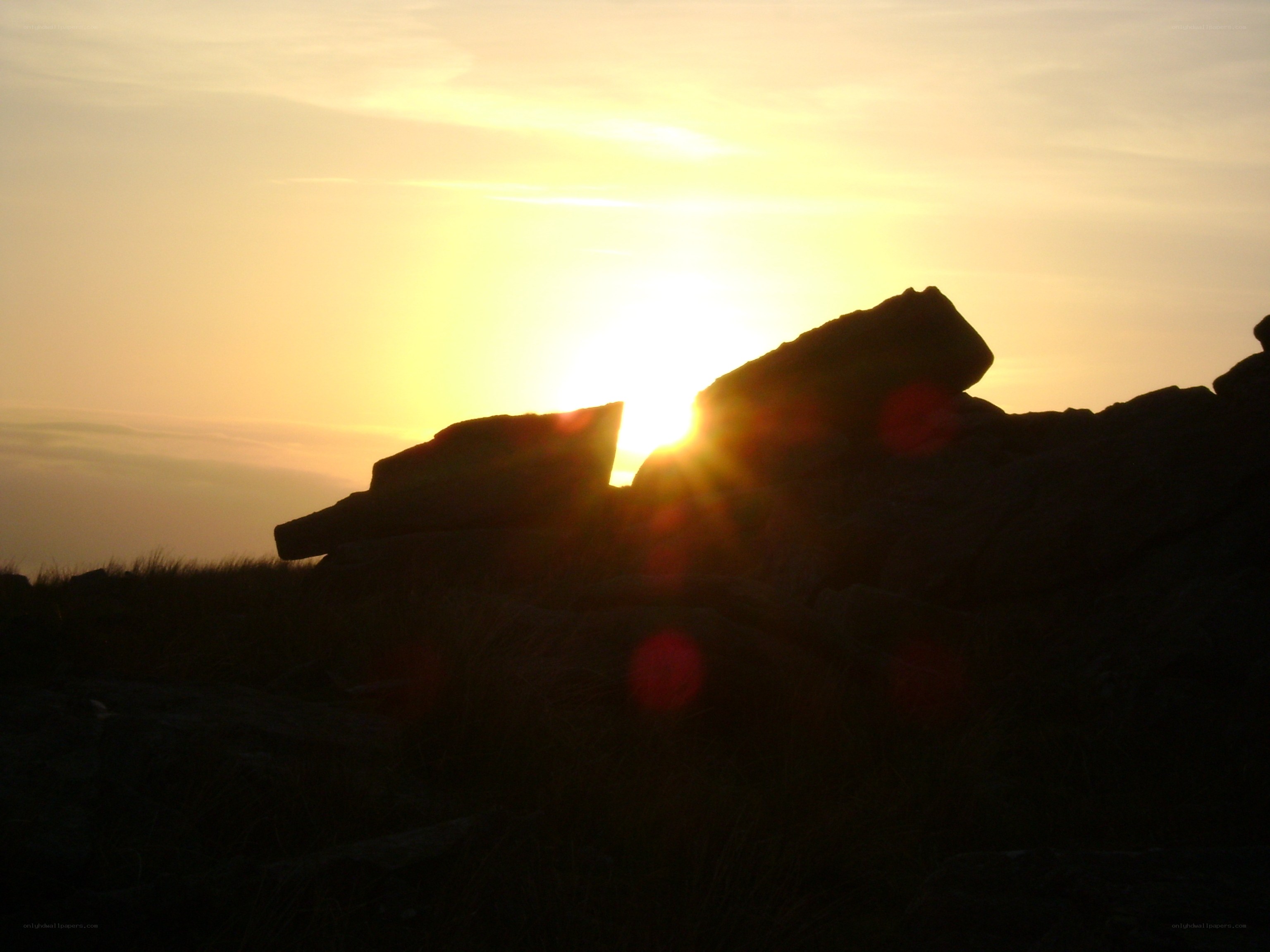 Sunset behind rocks