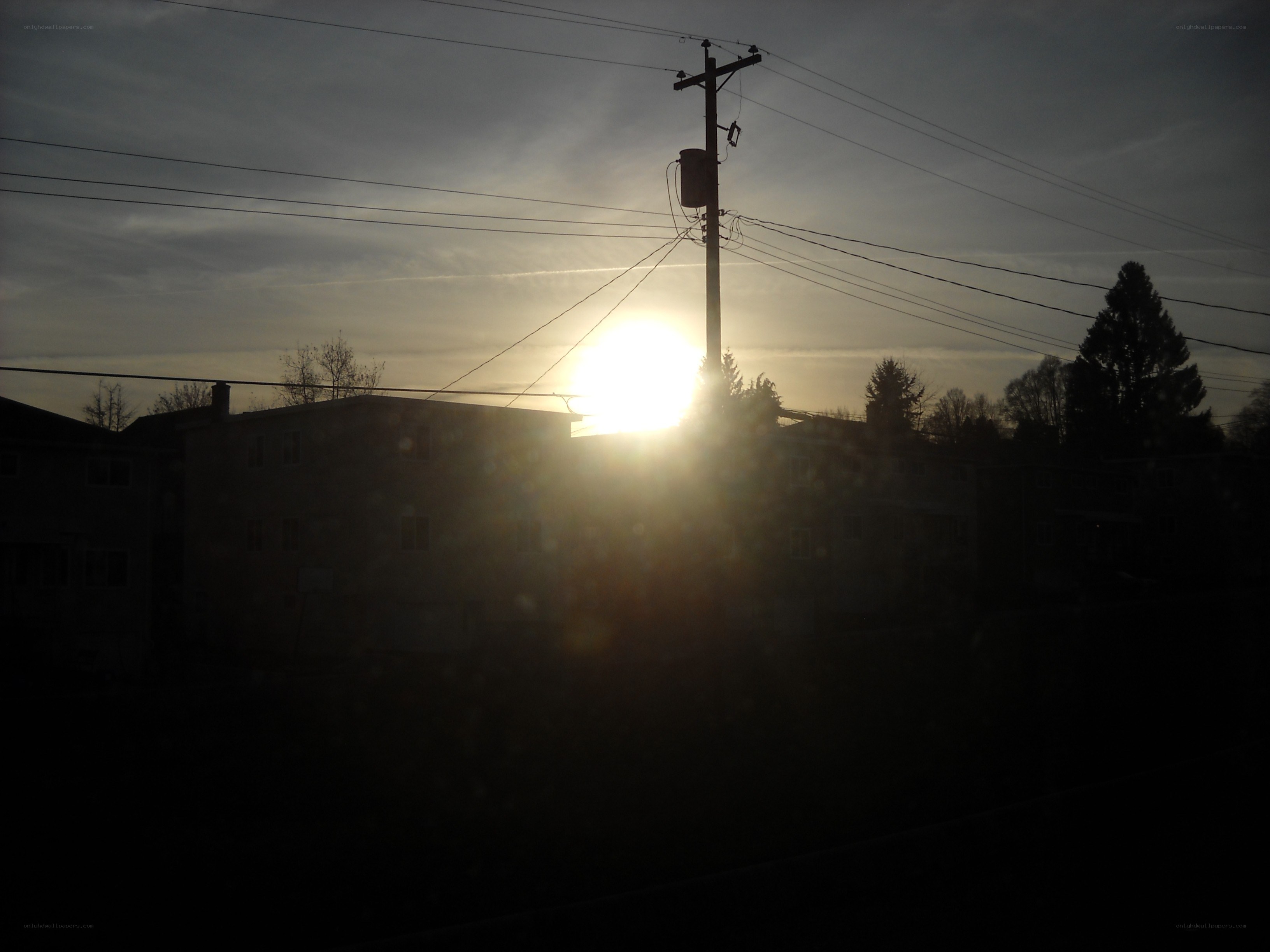 Sunset behind utility pole