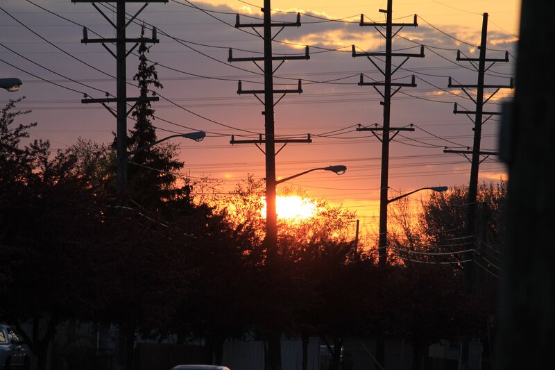 Sunset behind utility poles