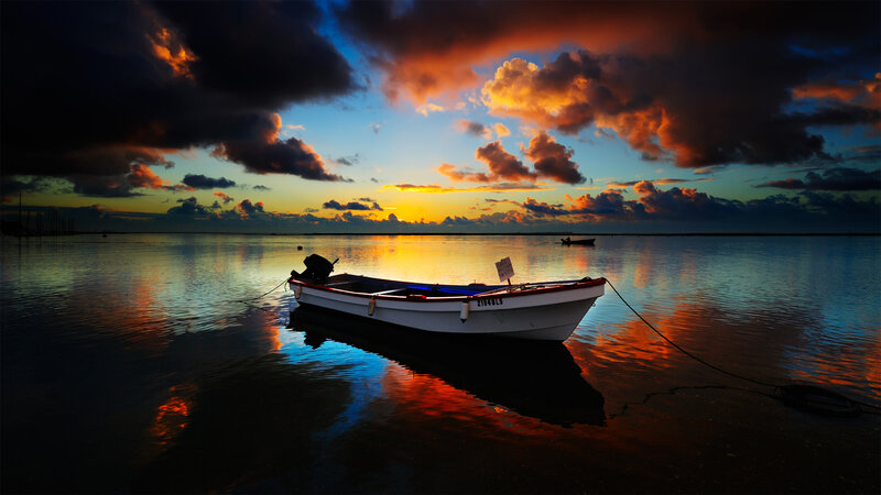 Sunset boat on calm water
